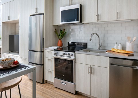 a kitchen with stainless steel appliances and white cabinets