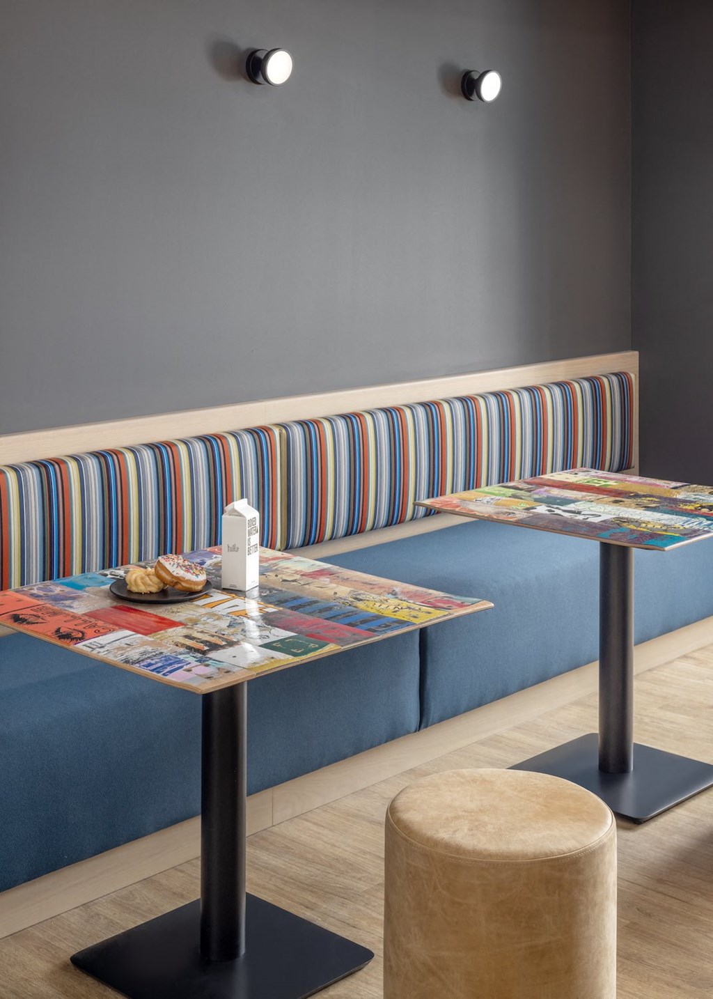 a seating area with a table and benches with colourful stripes