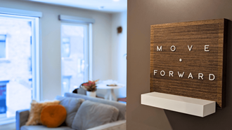a living room with a couch and a sign that says move forward