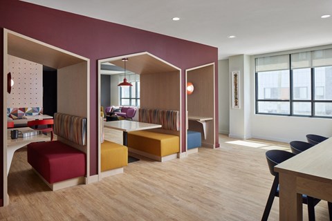 a dining room and living room with colorful furniture and a table