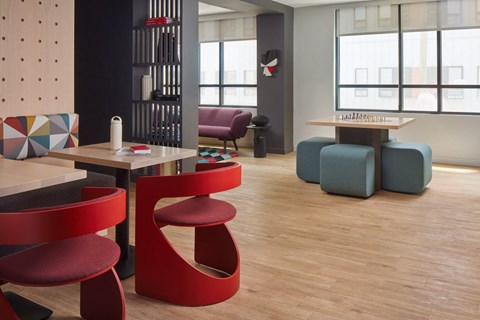 a seating area with tables and chairs in a room