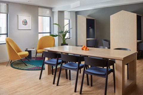 a dining room with a wooden table and chairs
