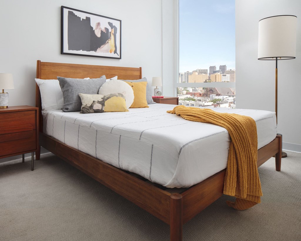 a bedroom with a bed and a window