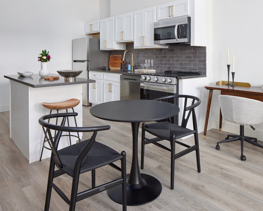 a kitchen and dining area with a table and chairs