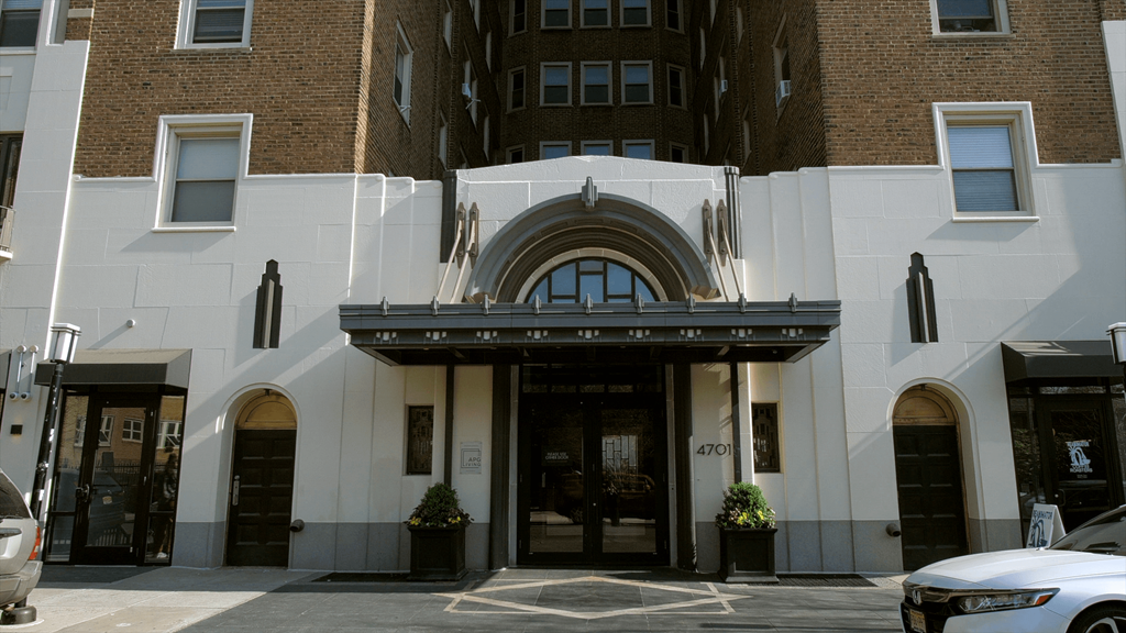 A building with a large arched entrance and a sign that reads