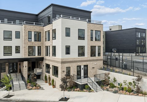 A modern building with a black fence in front.