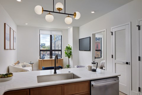A modern kitchen with a large island and a view of the city.