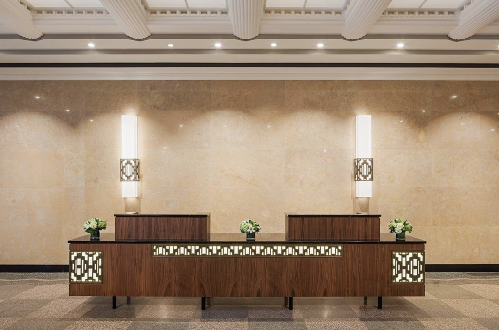 a lobby of a hotel with a reception desk