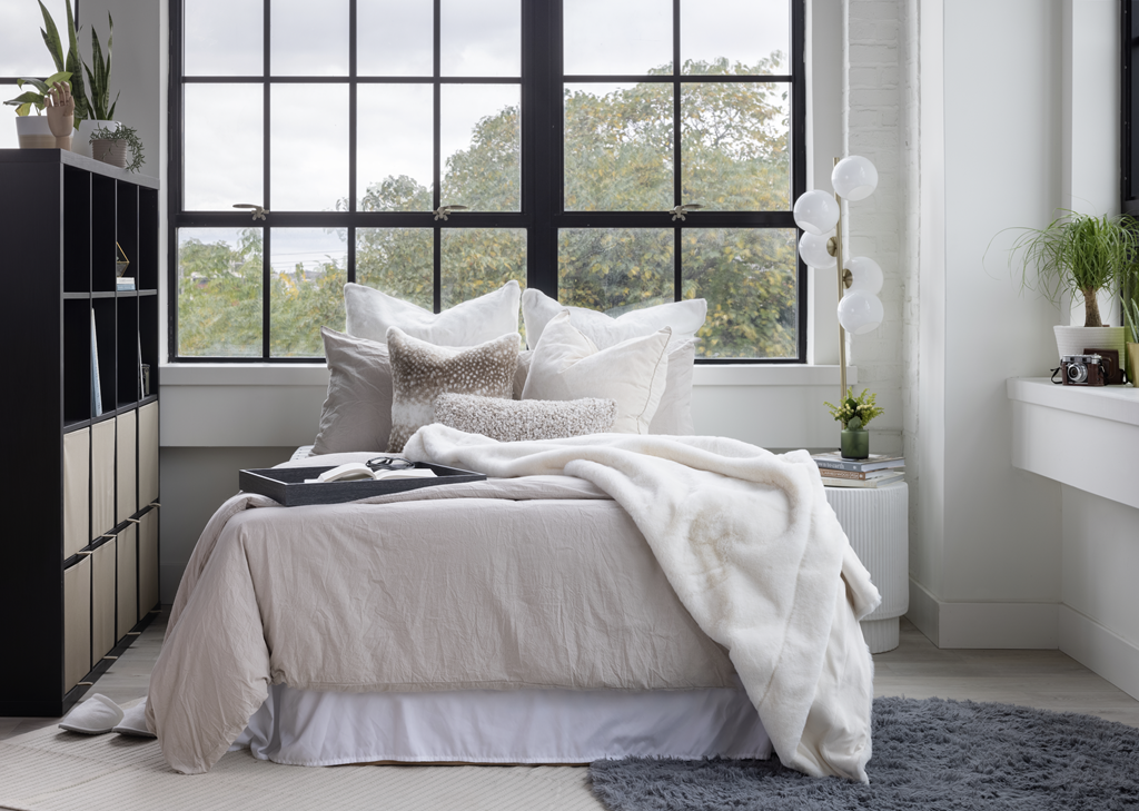 a bedroom with a bed in front of a window