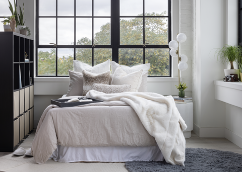a bedroom with a bed in front of a window