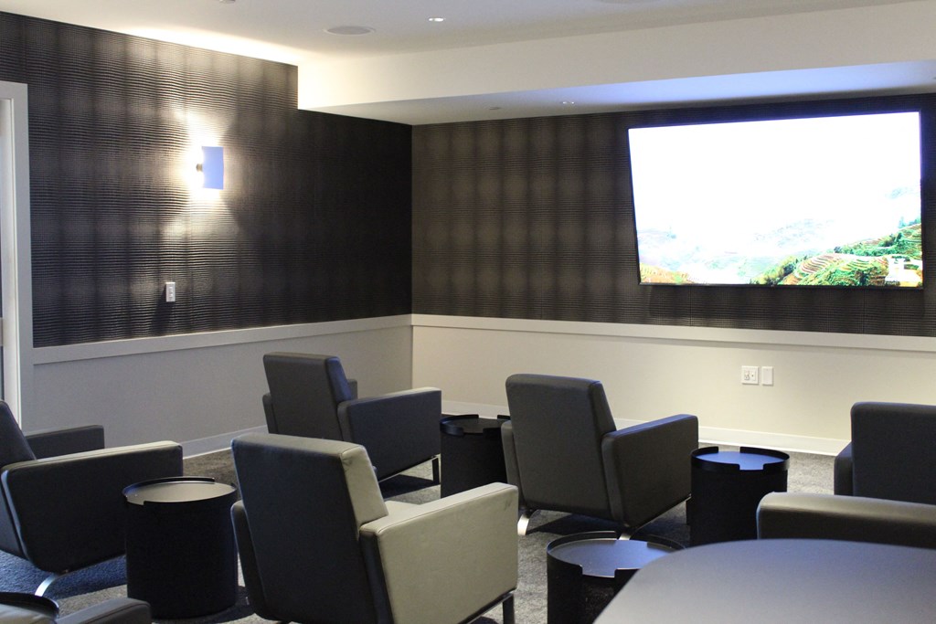a conference room with chairs and a projector screen