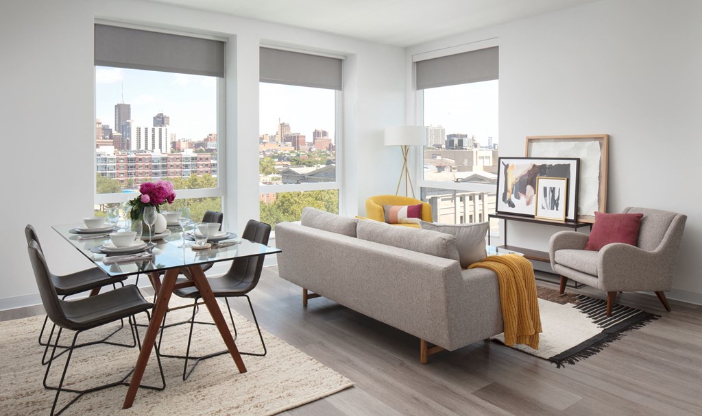 a living and dining room with a view of the city