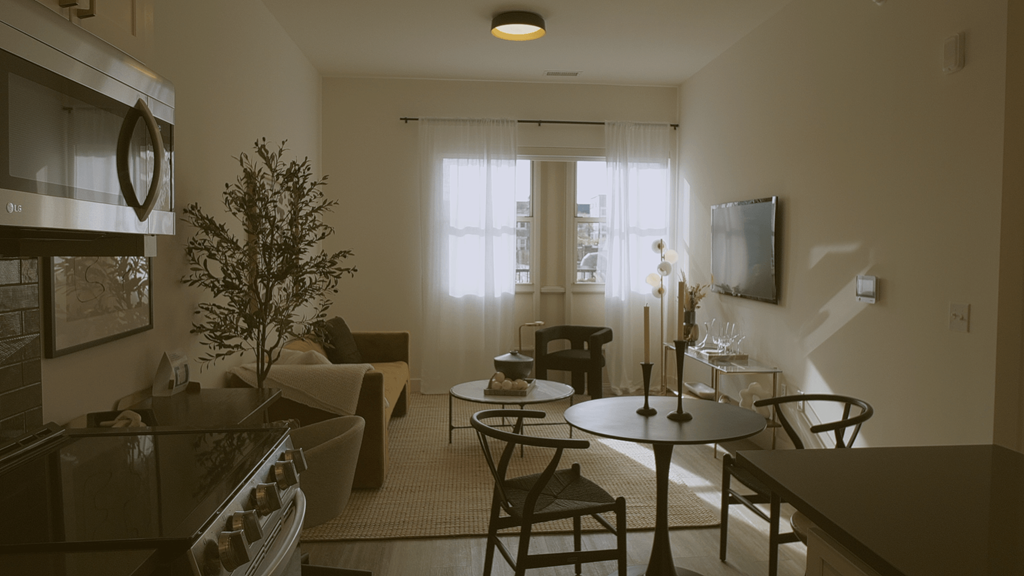 A living room with a couch, chairs, and a table.