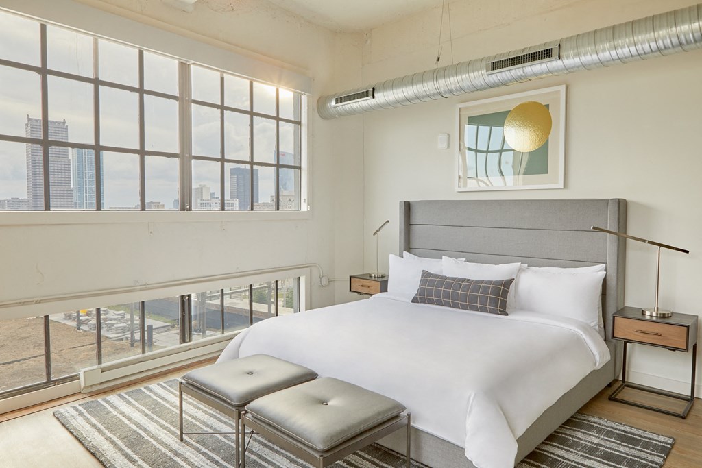 a bedroom with a large bed and a window