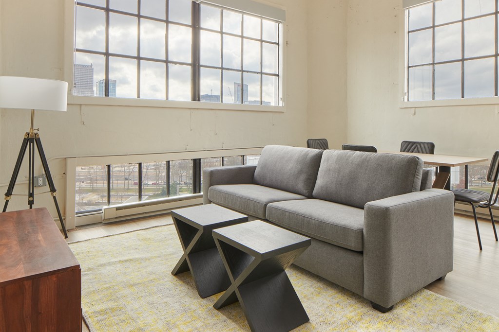 a living room with a couch and two tables