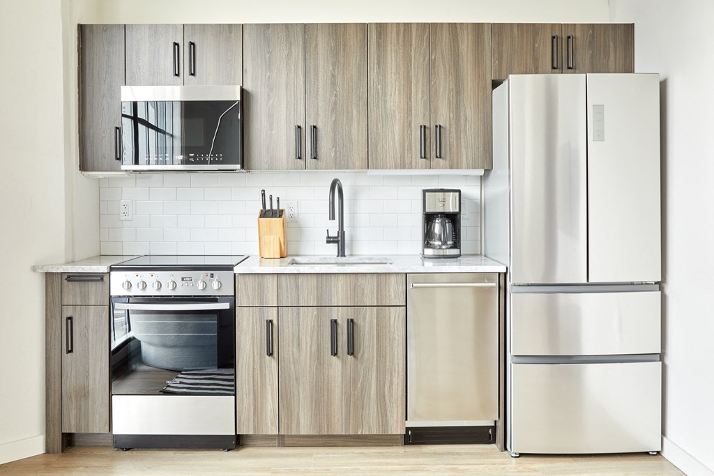 a kitchen with stainless steel appliances and wooden cabinets