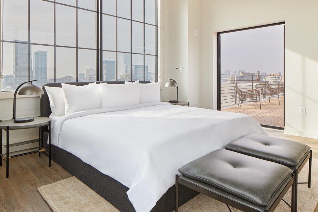 a hotel room with a bed and a large window