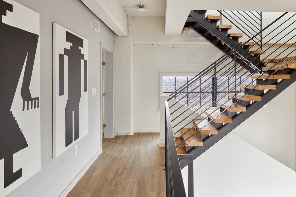 a staircase with wood treads and metal railings in a home