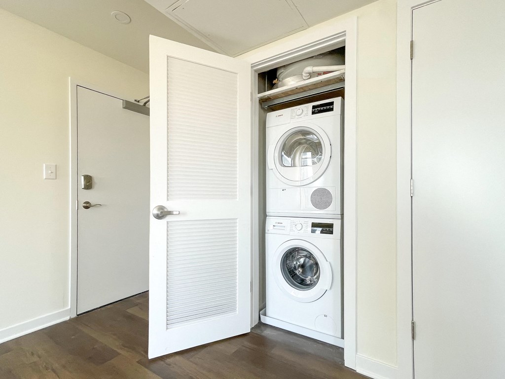 a washer and dryer in a closet in a room with a door