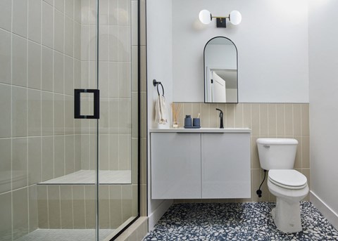 a bathroom with a toilet and a sink and a mirror at The Weaver, Philadelphia, PA, Pennsylvania, 19125