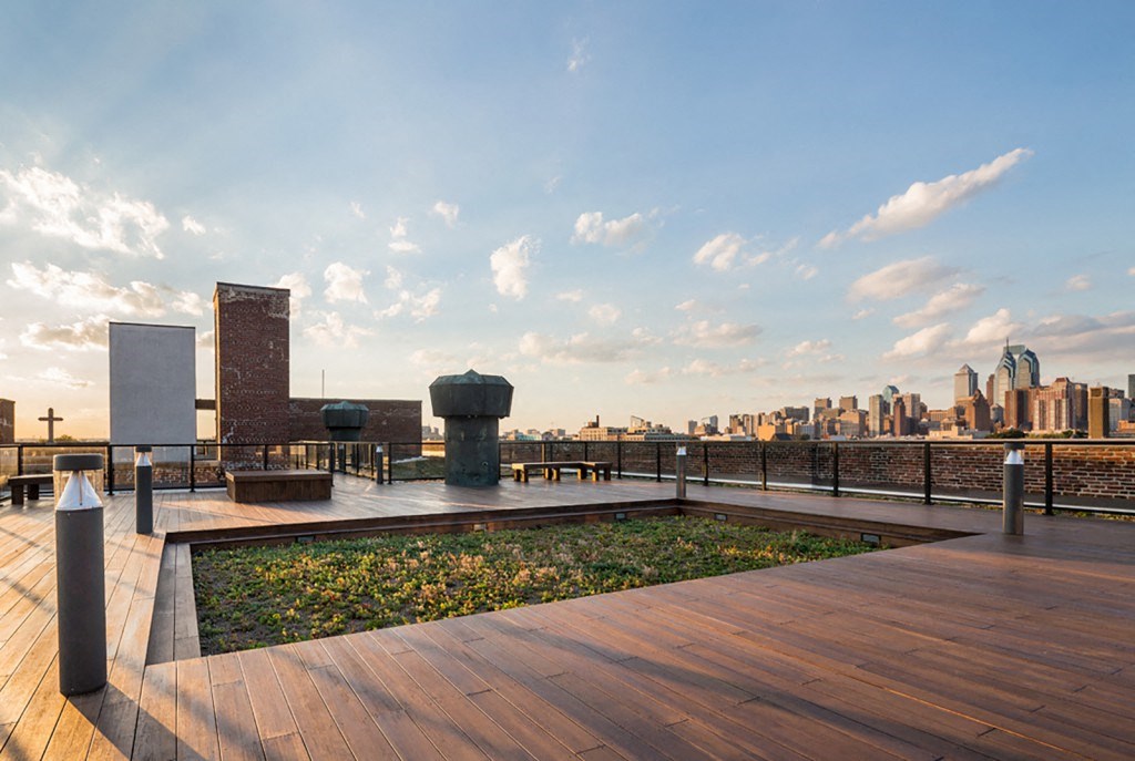a rooftop garden with a city skyline in the background