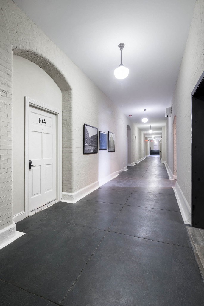 the hallway of a building with a white door
