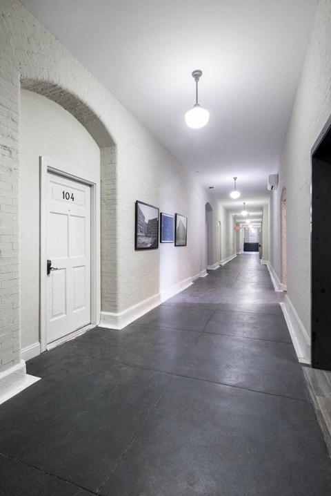 the hallway of a building with a white door