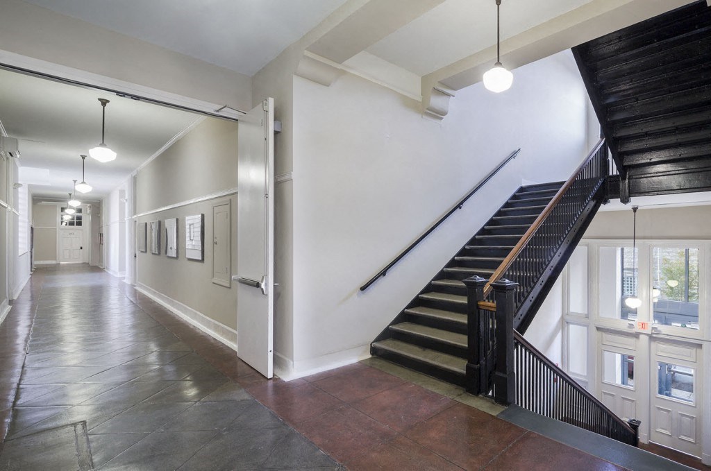 the lobby of a building with a staircase and a hallway withwindows and a staircase