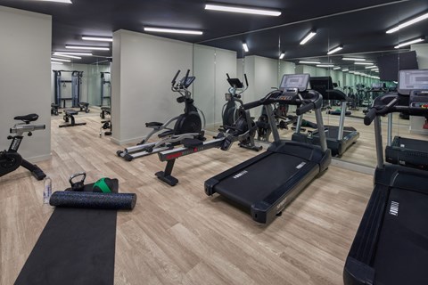 A gym with a variety of equipment including treadmills, stationary bikes, and weight machines. at The Commonwealth, Philadelphia, Pennsylvania