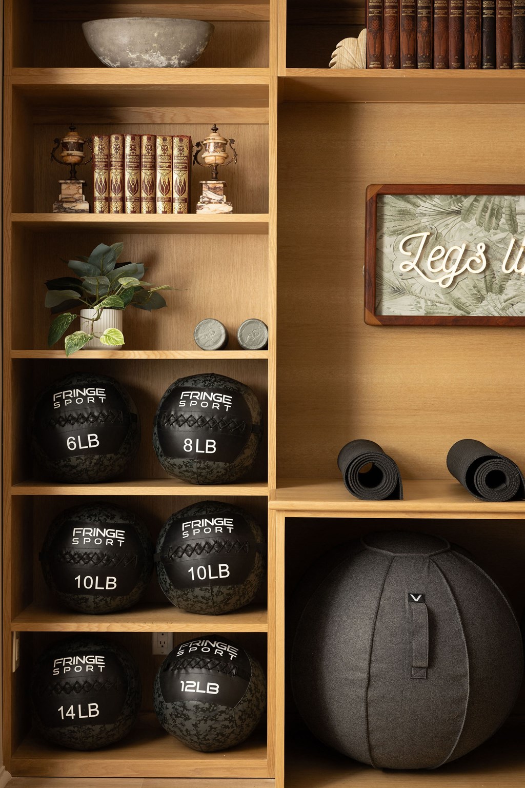 A shelf with exercise equipment and a sign at The PARKER on E Mulberry Apartments, Texas