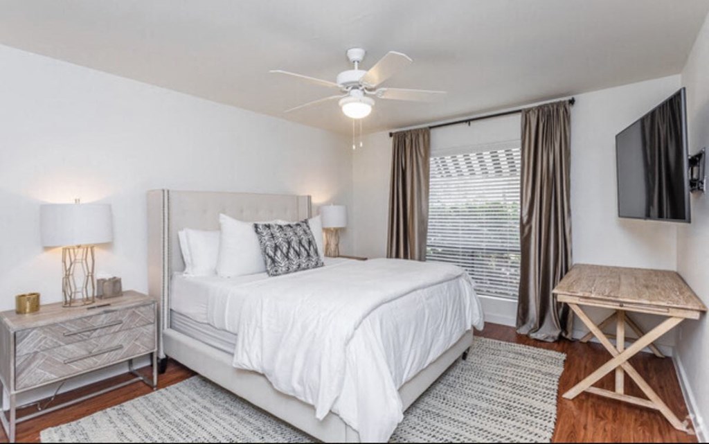 a bedroom with a bed and a ceiling fan
