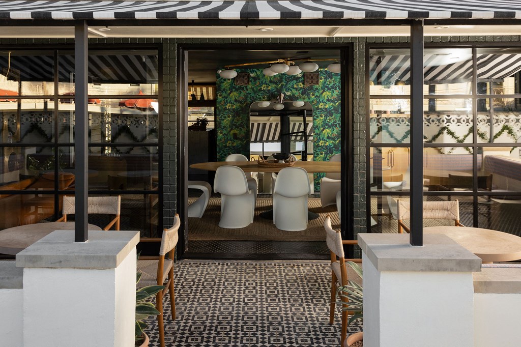 A restaurant with a black and white striped awning and a mosaic tile floor at The PARKER on E Mulberry Apartments, San Antonio, TX, 78209