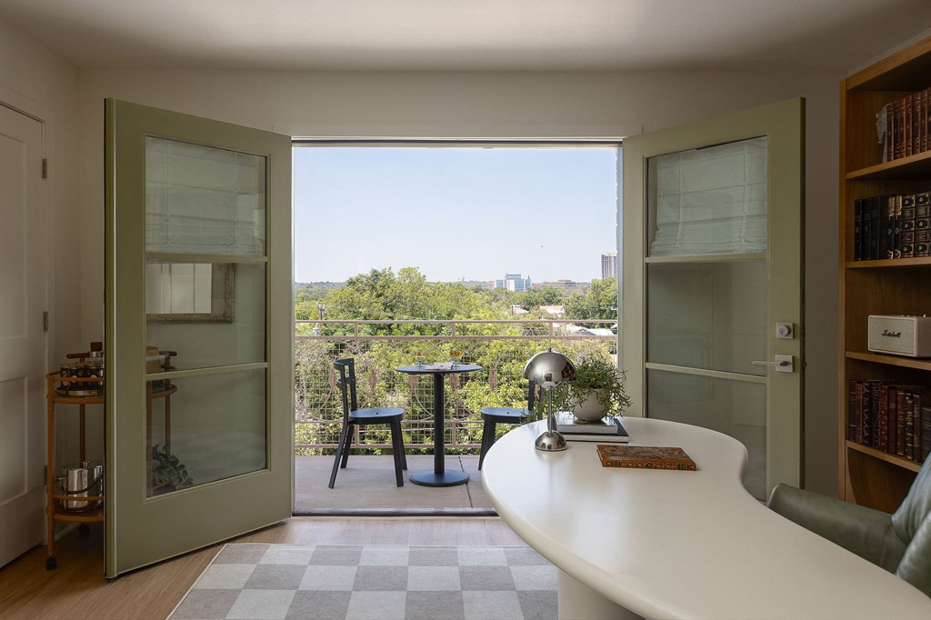 A small table with a globe on it is in the middle of a room at The PARKER on E Mulberry Apartments, San Antonio