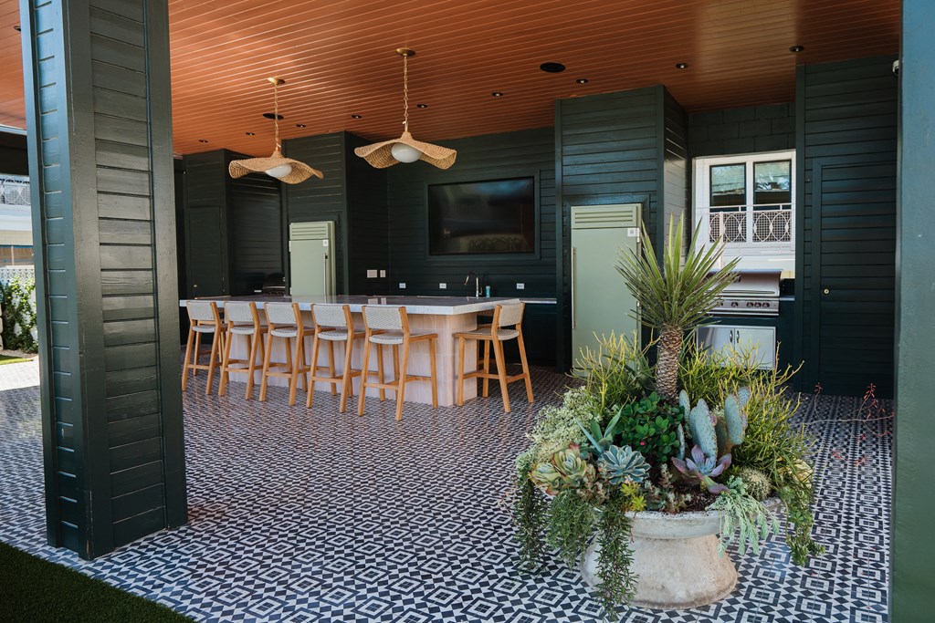 A black and white checkered floor with a potted plant in the middle at The PARKER on E Mulberry Apartments, Texas