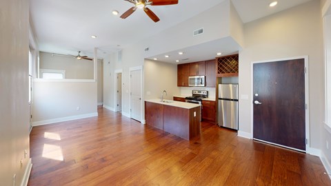 A kitchen with a refrigerator, sink, and stove is visible.