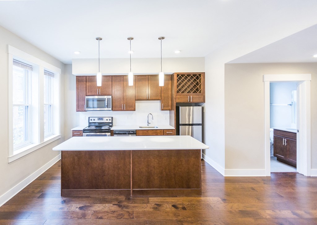 a kitchen with wooden cabinets and a white counter top