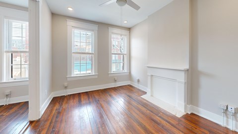 A room with wooden floors and a fireplace.