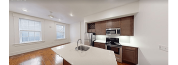 A kitchen with brown cabinets and a white countertop.