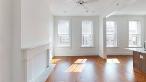A room with wooden floors and white walls.