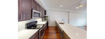 A kitchen with a stove top oven and microwave.