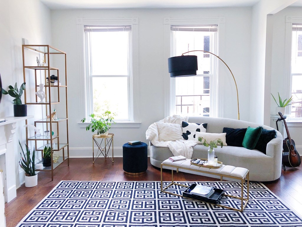 a living room with a white couch and a rug