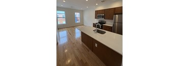 A kitchen with wooden cabinets and a white countertop.