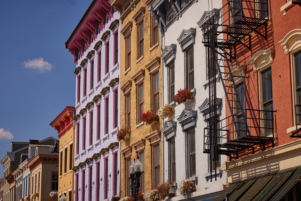 A row of buildings with fire escapes on the side.