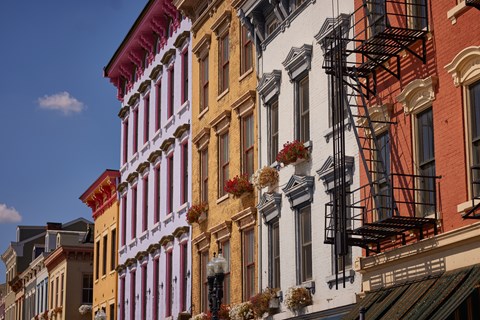 A row of buildings with fire escapes on the side.