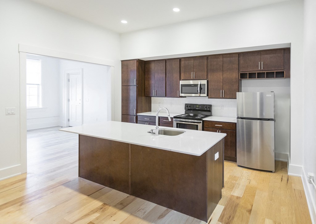 a large kitchen with wooden cabinets and stainless steel appliances