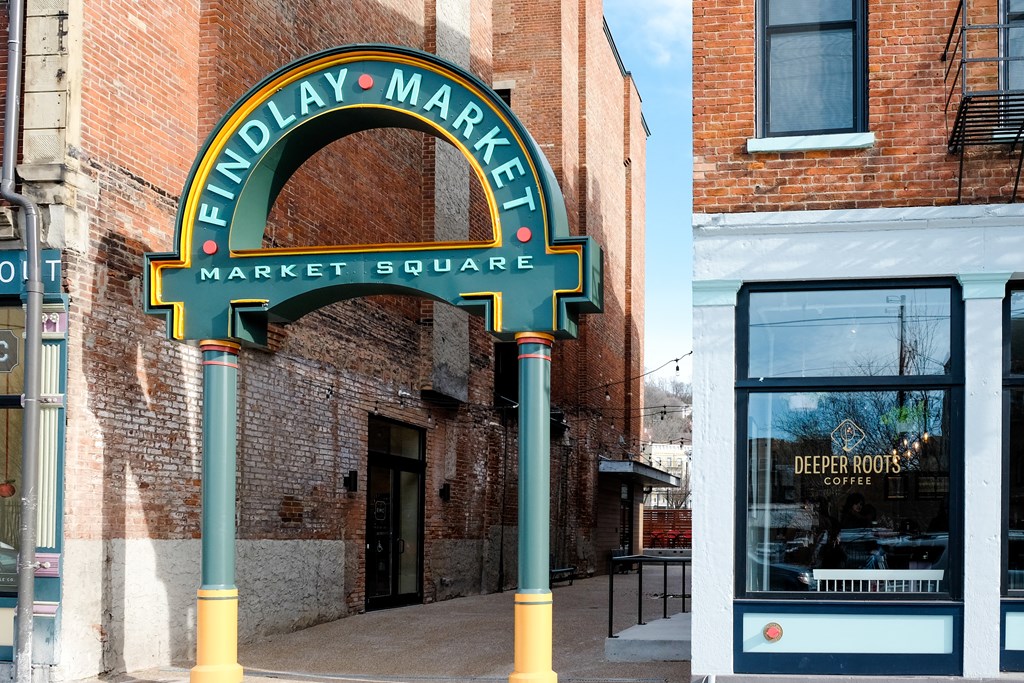 a sign that reads midway market market square in front of a brick building