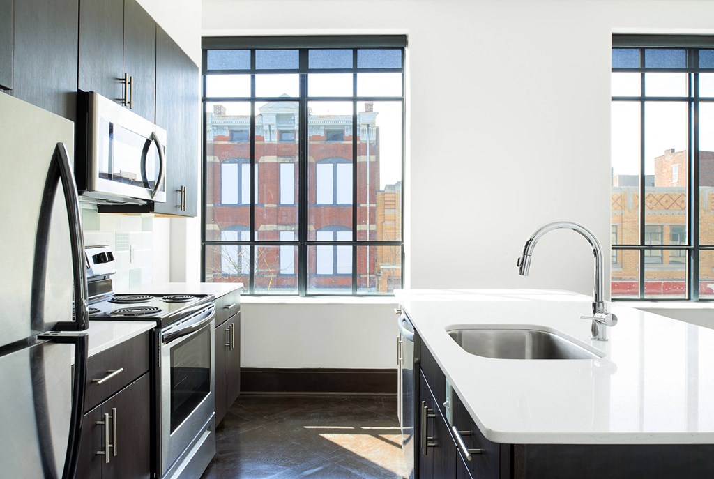 an empty kitchen with a sink and a window
