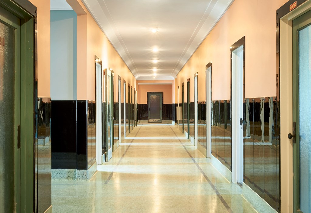 a hallway with glass doors and a tiled floor