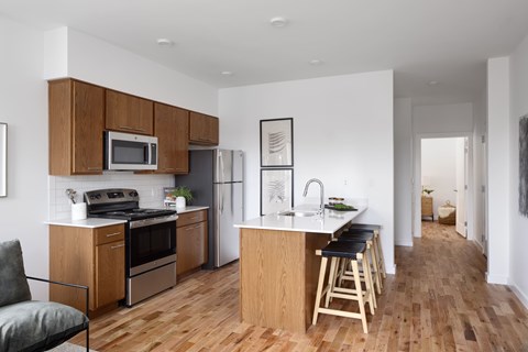 A kitchen with wooden floors and furniture.