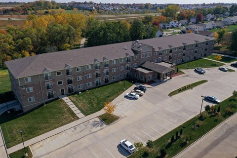 a large building with a parking lot in front of it